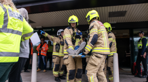 Firefighters carrying out a patient from the exercise.